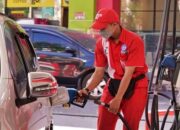 Petugas SPBU Pertamina saat melayani pengisian bahan bakar minyak (BBM) jenis Pertalite ke salah satu mobil konsumen
